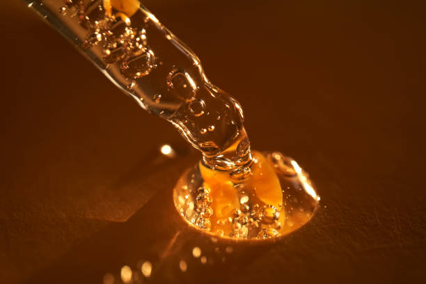 istock Pipette with serum shimmering in the sun on a beige background. 2160402555