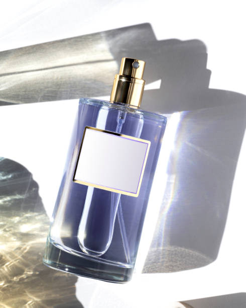 istock Bottle of perfume in shadows and caustics 2160405993