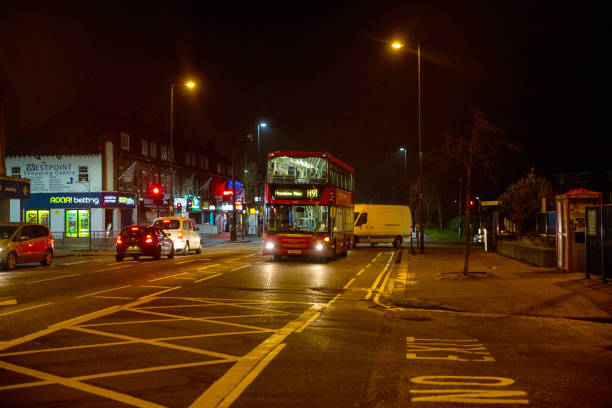 London Underground Tube station entrance at Westminster in night city lights. Public Subway logo on foreground and double decker in background. Selective focus on London Underground logo Shallow depth of field. London, UK, 15th Dec 2016