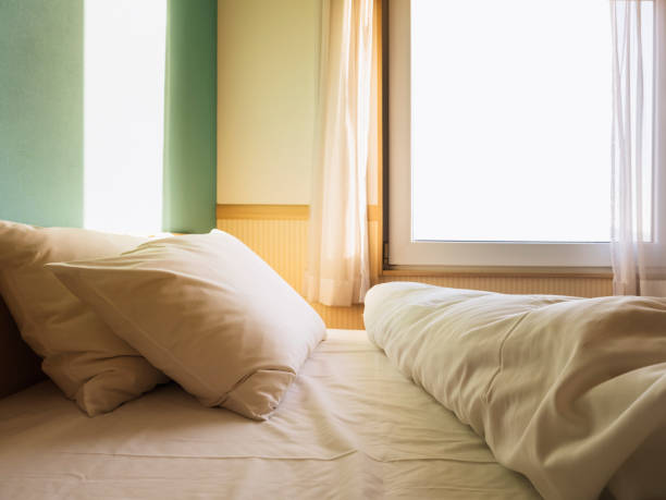 Bed Mattress and Pillows Bedroom with morning light window frame