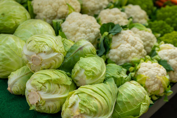 a bunch of green and white vegetables including cauliflower and cabbage