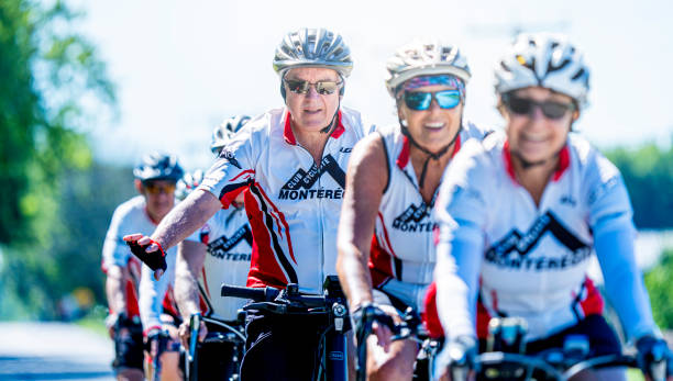 Saint-Hugues, Quebec, Canada, July 1st, 2024. A group of elderly cyclists from the Montérégie Cycling Club riding bikes on the road in Saint-Hugues on a sunny summer day.