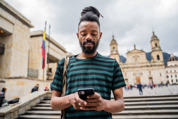 istock Young man using mobile phone outdoors 2160417610