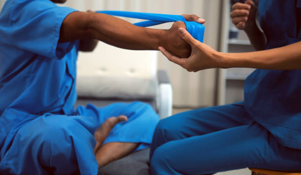 istock Professional physical therapist examines and cares for a young man in a physical therapy center, treating muscles and injuries of a man in a hospital. 2160418993
