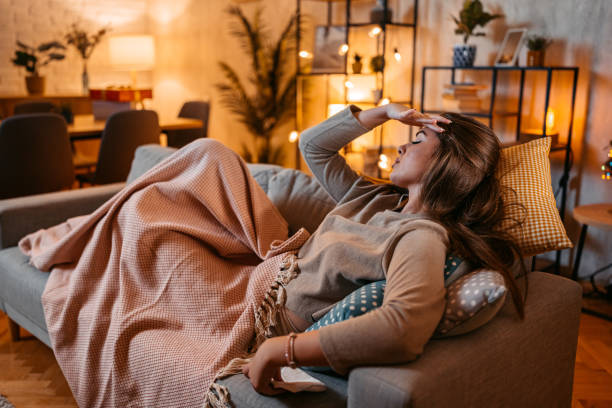 istock Young Woman Having A Headache At Home At Night 2160420036