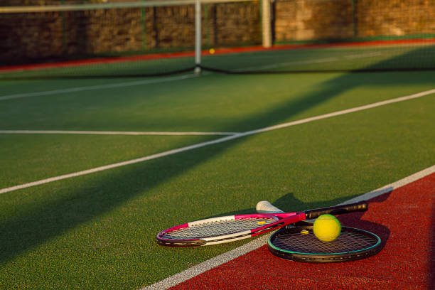 istock Two tennis racket and a ball 2160420974