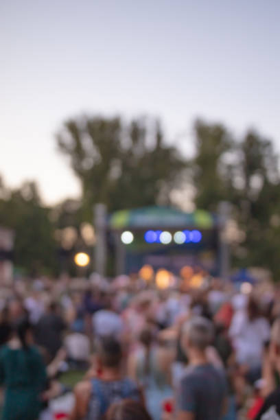 istock De-focused people enjoying daylight public festival. 2160421569