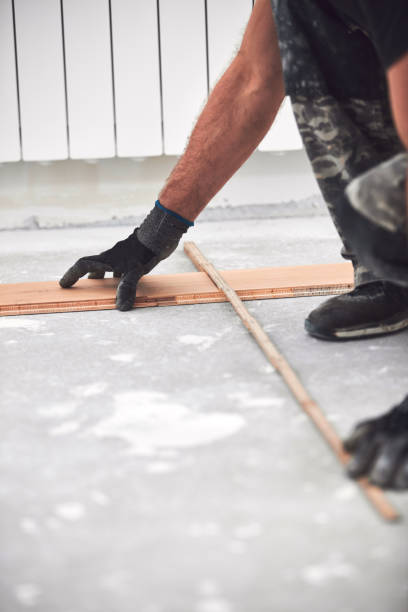 istock Professional handyman installing laminate flooring in a new apartment. 2160422069