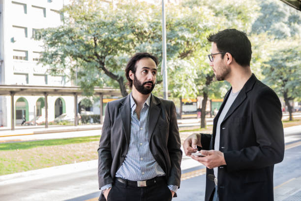 Coworkers talking on bus stop