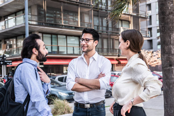 istock Coworkers talking on the city 2160422560