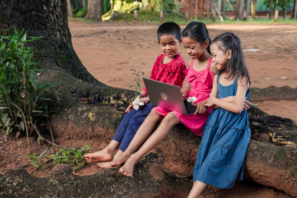 istock Cambodian children using digital tablet in village, Cambodia 2160422561