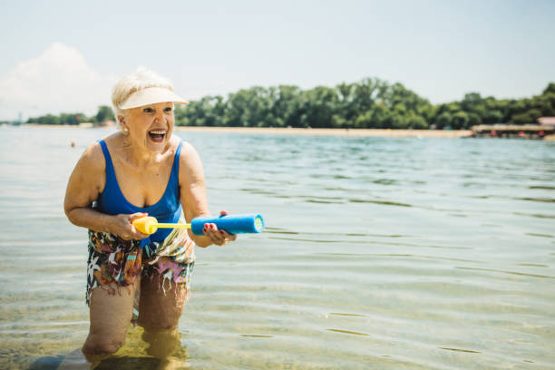 istock Happy senior woman on the beach 2160423558