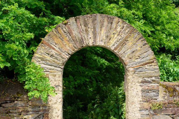 istock Board stone arch in a garden 2160424278