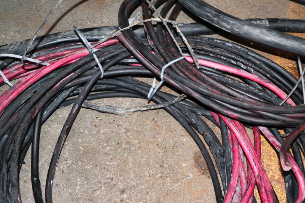 istock Damaged Electrical Wires On Concrete Floor 2160427052
