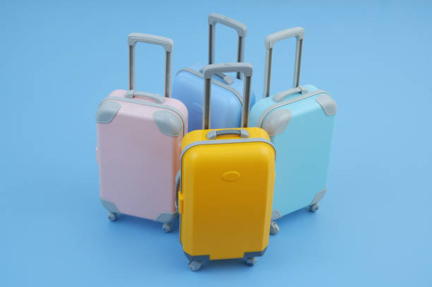 istock Many different colorful suitcases on blue background. 2160427096
