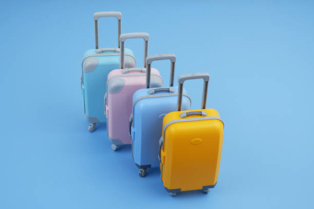 istock Many different colorful suitcases on blue background. 2160427191
