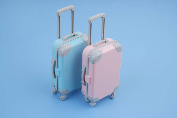 istock Pink and blue suitcases on blue background. T 2160427259
