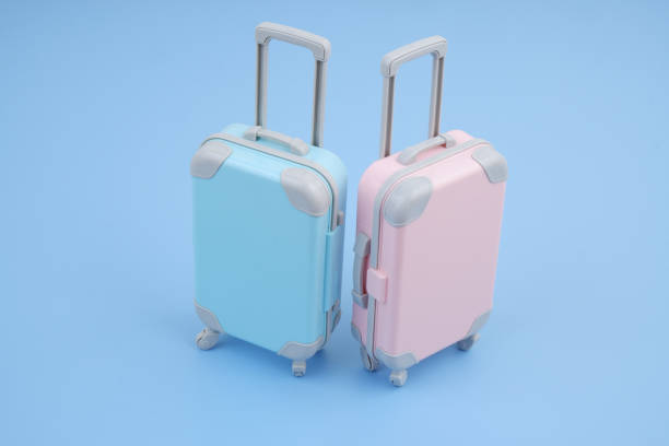 istock Pink and blue suitcases on blue background. T 2160427264