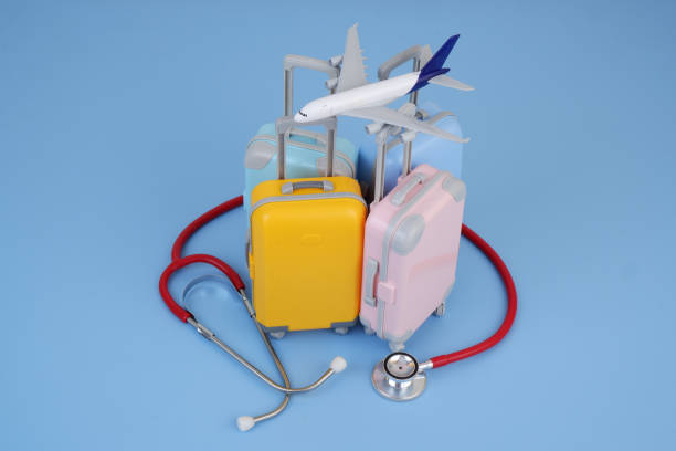 istock Airplane model on many different travel suitcases and red stethoscope. 2160427415