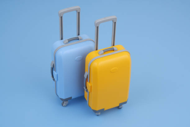 istock Blue and orange travel suitcases on blue background. 2160427479