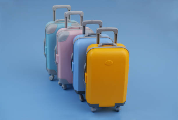 istock Many different colorful suitcases on blue background. 2160427530