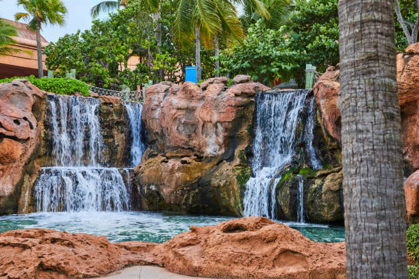 istock Serene Man-Made Waterfall in Lush Tropical Oasis 2160427820