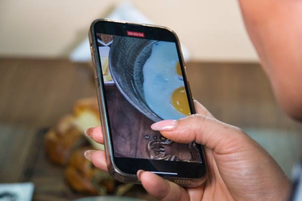 istock Person Filming Scrambled Eggs on Smartphone 2160427975