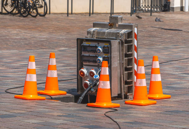istock an electrical box with electricity and electrical sockets pulled out from the sidewalk in the city, fenced with orange posts 2160429653