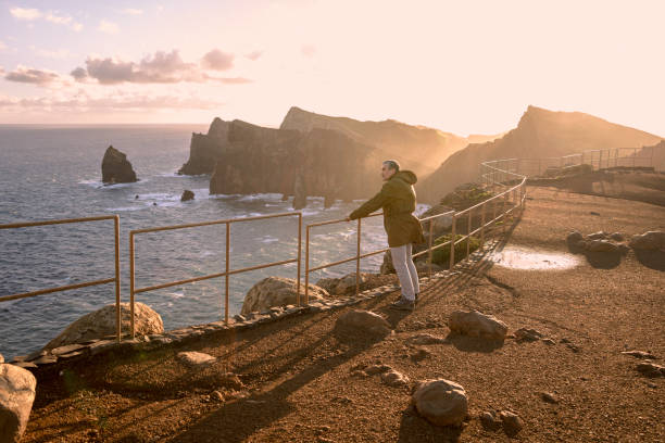istock Man at High Ocean Viewpoint at Sunrise. Back to Nature Trip. 2160429792