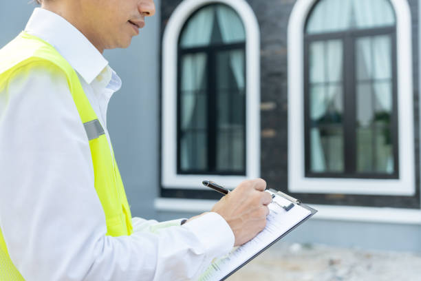 istock inspector or engineer is inspecting construction and quality assurance new house using a checklist. Engineers or architects or contactor work to build the house before handing it over to the homeowner 2160429948