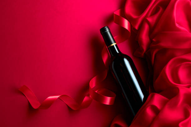 istock Bottle of red wine on a red background. 2160431455