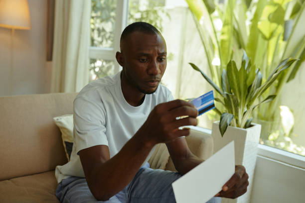 istock Man Opening Letter With Credit Card 2160432280