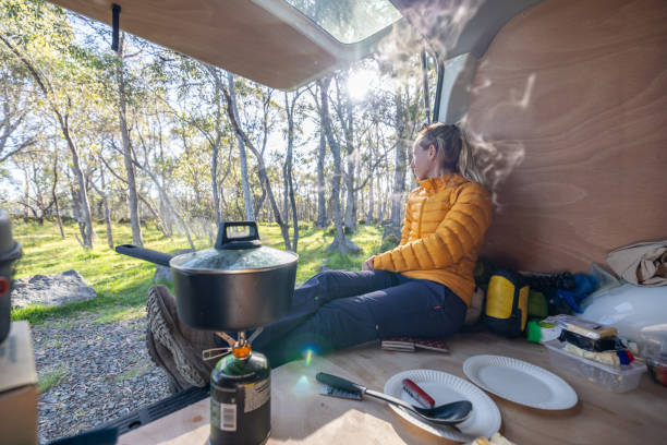 istock Woman Relaxing in Camper Van with Forest View 2160434857
