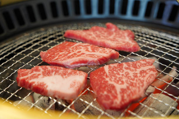 istock raw beef on charcoal grill, closeup of raw beef on charcoal grill 2160435708