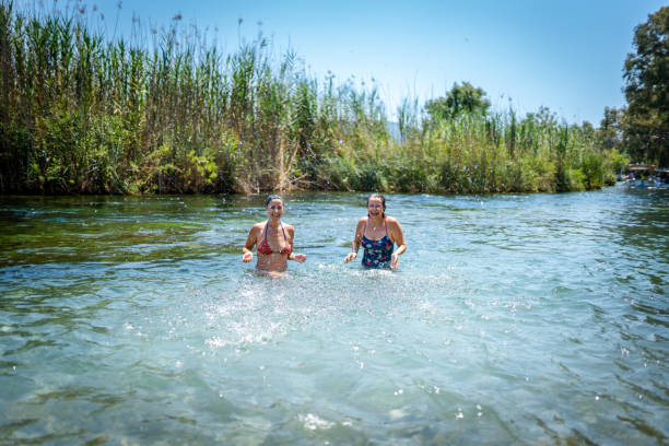 istock Best friends swimming together in a river 2160435863