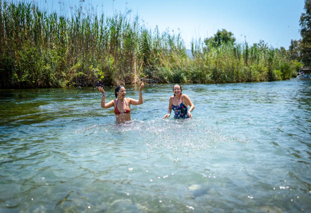 istock Best friends swimming together in a river 2160435864