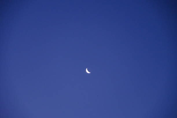 The waning moon in the blue sky