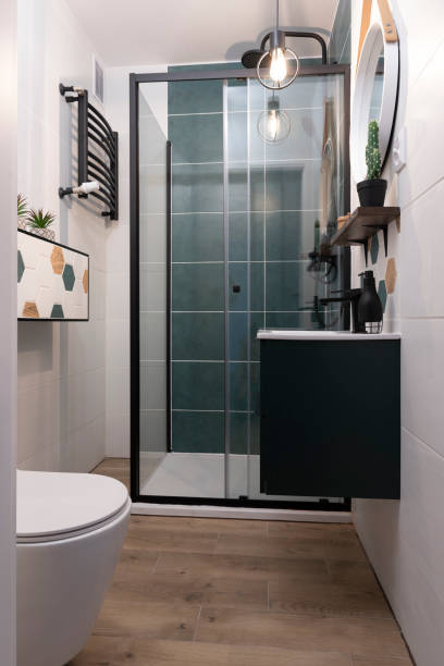 istock Home interior of modern bathroom with shower, ceramic bathroom sink on cupboard and pattern tile  on the wall. Elegance and luxury in new apartment. 2160437495