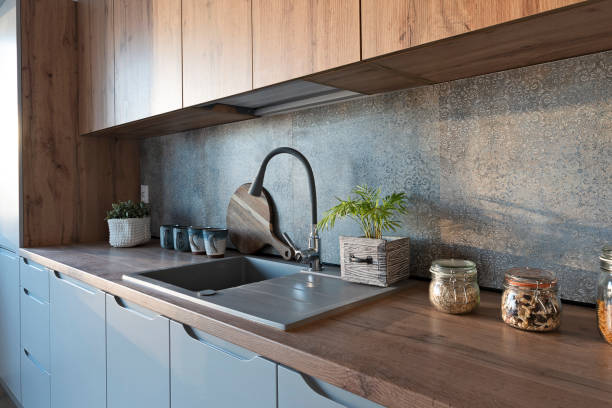 istock Modern kitchen in dining interior with wooden countertop, kitchen sink  and pattern tile on the wall. Home decor. 2160437887