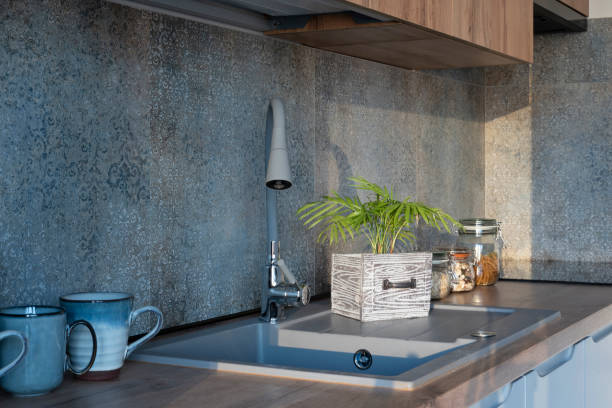 istock Modern kitchen in dining interior with wooden countertop, kitchen sink  and pattern tile on the wall. Home decor. 2160437888