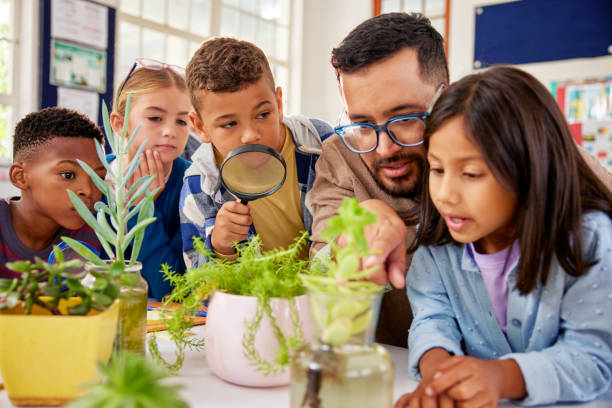 istock Teacher explaining the life cycle of plants to elementary class 2160438228