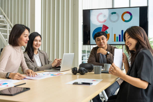 istock Happy diverse group Asian business start up freelance team analyzing statistics financial. Group Team of business people meeting conference discussion various topic corporate concept in office. 2160438903