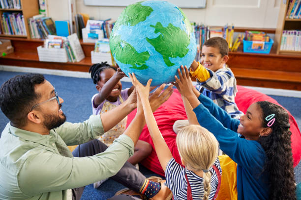 istock Happy multiethnic children holding planet earth globe at school 2160439080
