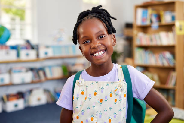 istock Happy smiling black girl looking at camera at school 2160439119