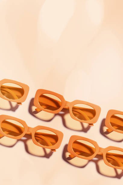 istock Pattern of Trendy sunglasses with Yellow Frame on peach background, beach vibes, summertime mood, sunlight shadow, Summer vacation, summer rest concept. Minimal style layout of eyeglasses 2160439470