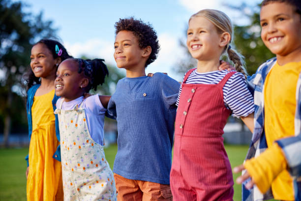 istock Happy multiethnic children friends jumping in a row 2160439559