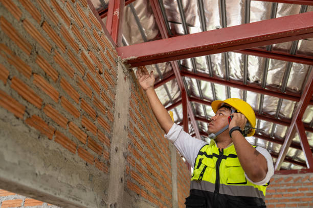 istock Asian male construction worker control and checking steel roof structure quality work at construction site. 2160440100