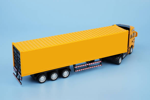 istock Yellow cargo truck on blue background. Copy space for text. 2160440344