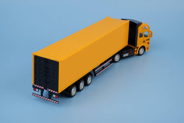 istock Yellow cargo truck on blue background. Copy space for text. 2160440369
