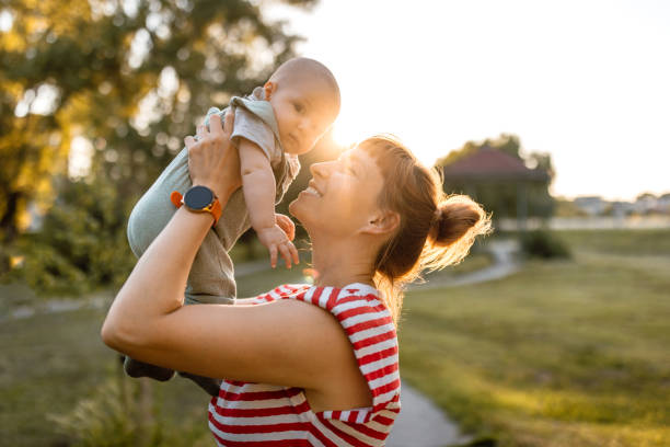 istock Mother throwing baby up in the air, having fun 2160441328